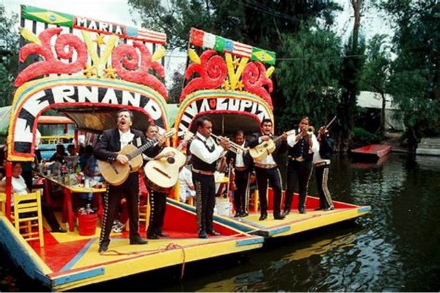 A mariachi band performing on a trajinera boat.