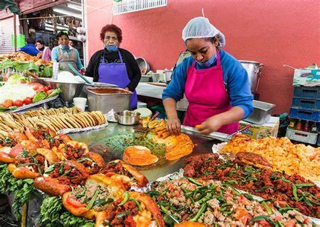 Street vendor preparing traditional Mexican street food.