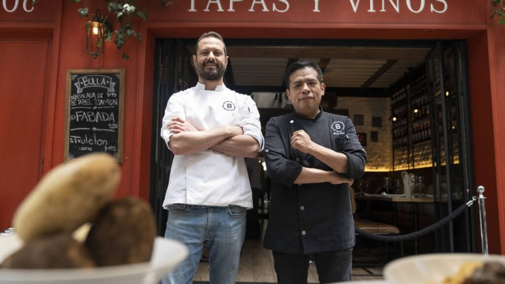 Chef Pedro Martin, owner of Bulla Condesa, standing proudly in front of his restaurant